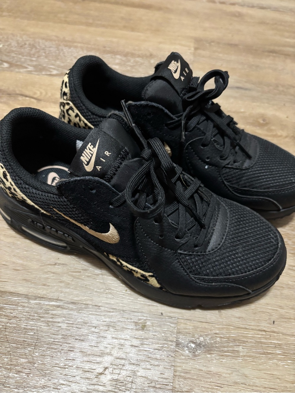 Nike Women's Black Sneakers with Gold Swoosh and Leopard Trim